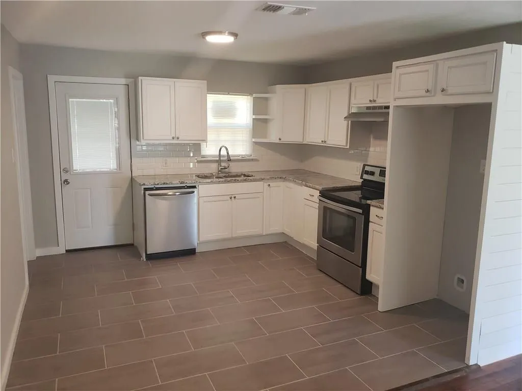 Kitchen with the sink under the window — after renovation